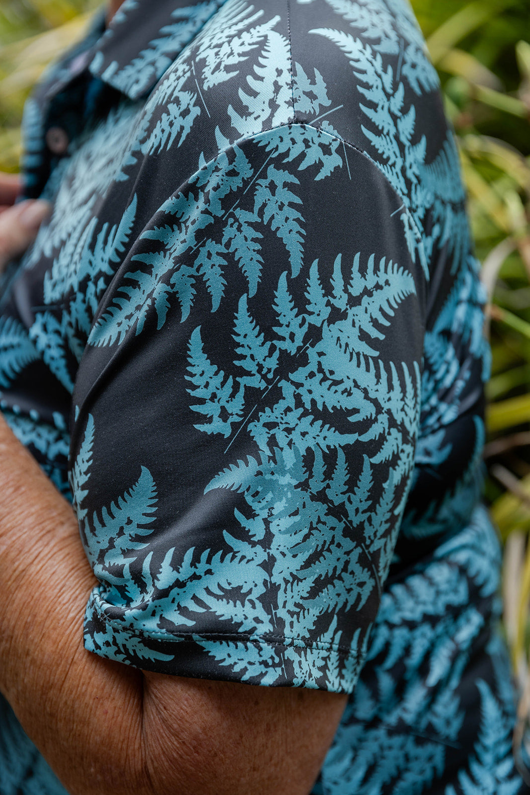 Women’s teal golf polo shirt with silver fern print – breathable, stylish activewear for comfort and performance on the course by Kaleo