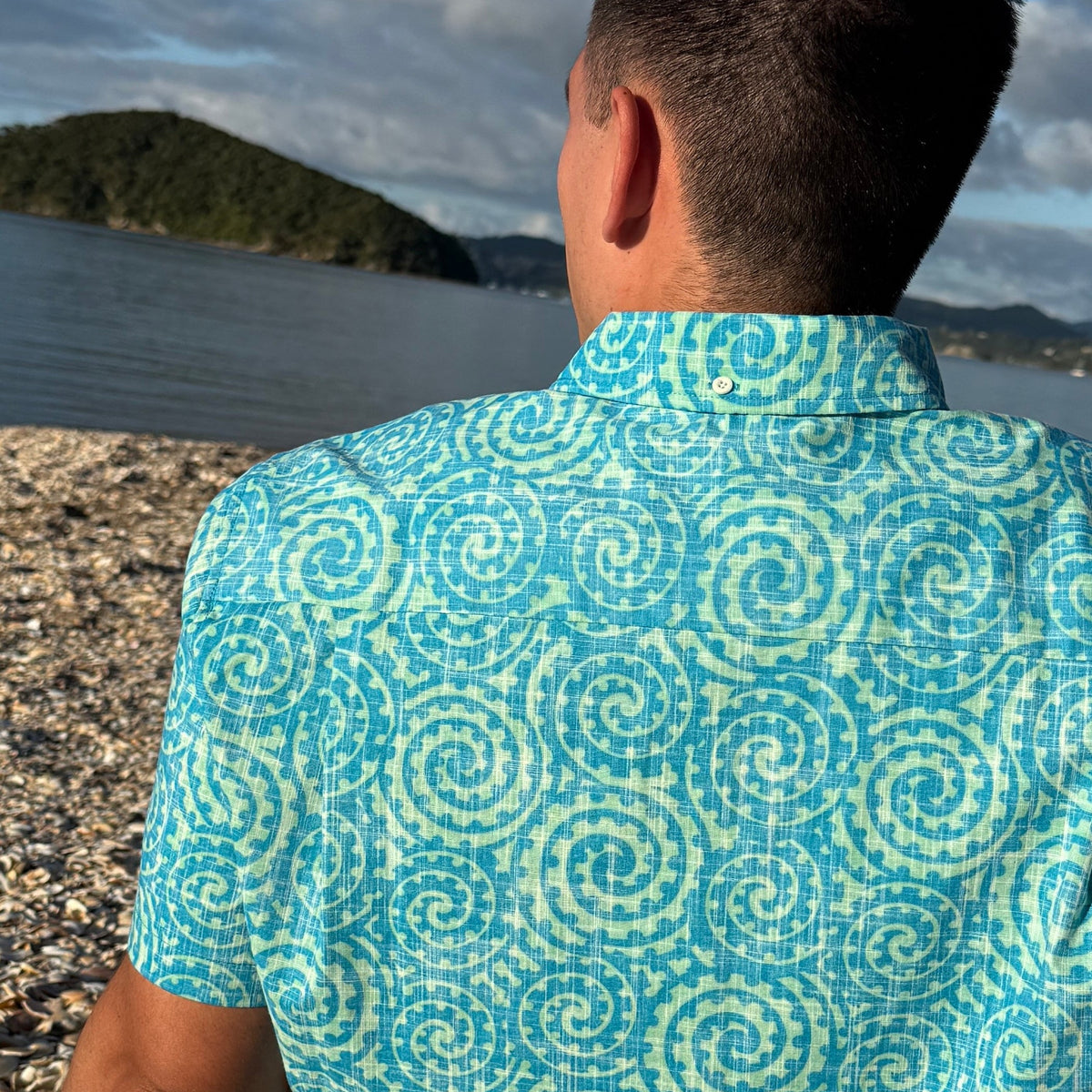 Takarangi Kiwi Classic men's short sleeve shirt in turquoise, featuring original New Zealand artwork
