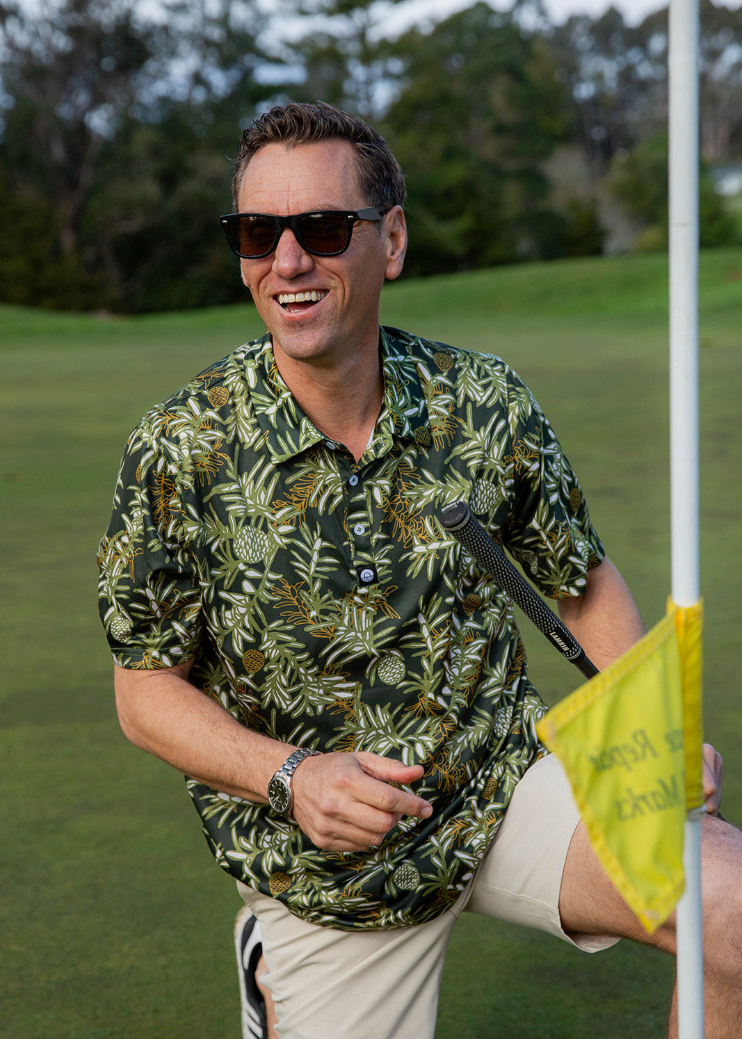 Kauri Men’s Golf Polo in deep green with native kauri design. NZ golf shirt made from breathable, moisture-wicking fabric for all-day comfort.