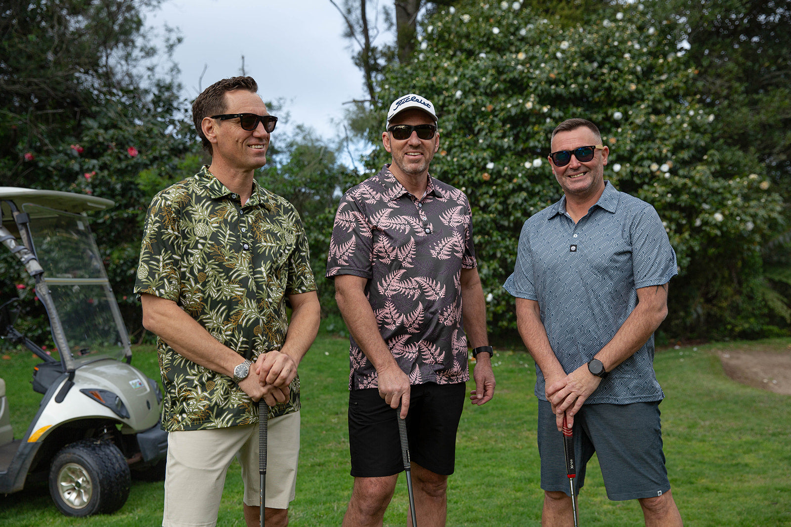 Pakati Men’s Golf Polo in dark grey with Māori-inspired geometric design. NZ golf shirt made from breathable, quick-dry performance fabric.