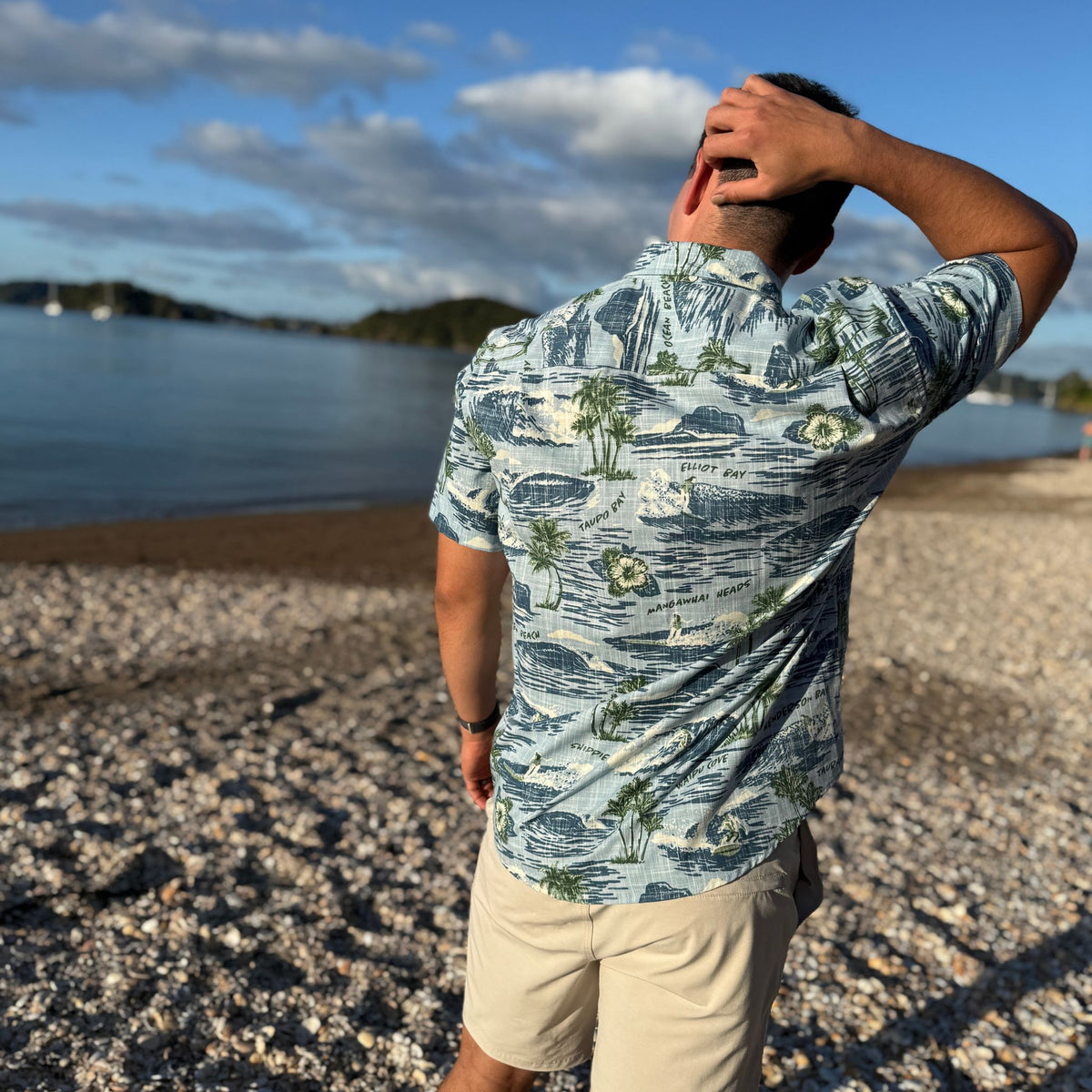 Surf Northland Kiwi Classic men's short sleeve shirt featuring a blue coastal surf-inspired print.
