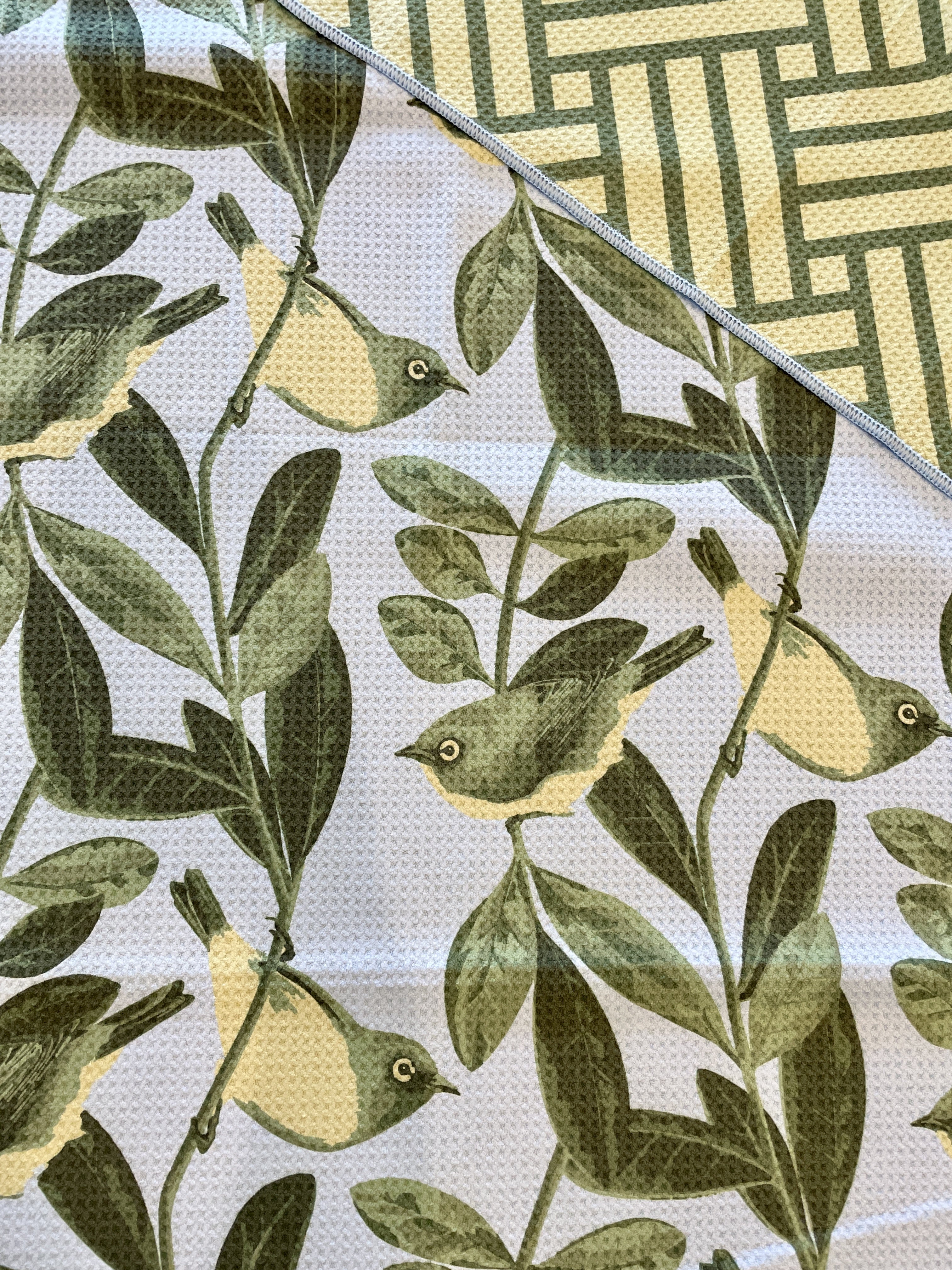 Blue Tauhou beach towel featuring native NZ silvereye bird and foliage design – absorbent quick-dry towel by Kaleo