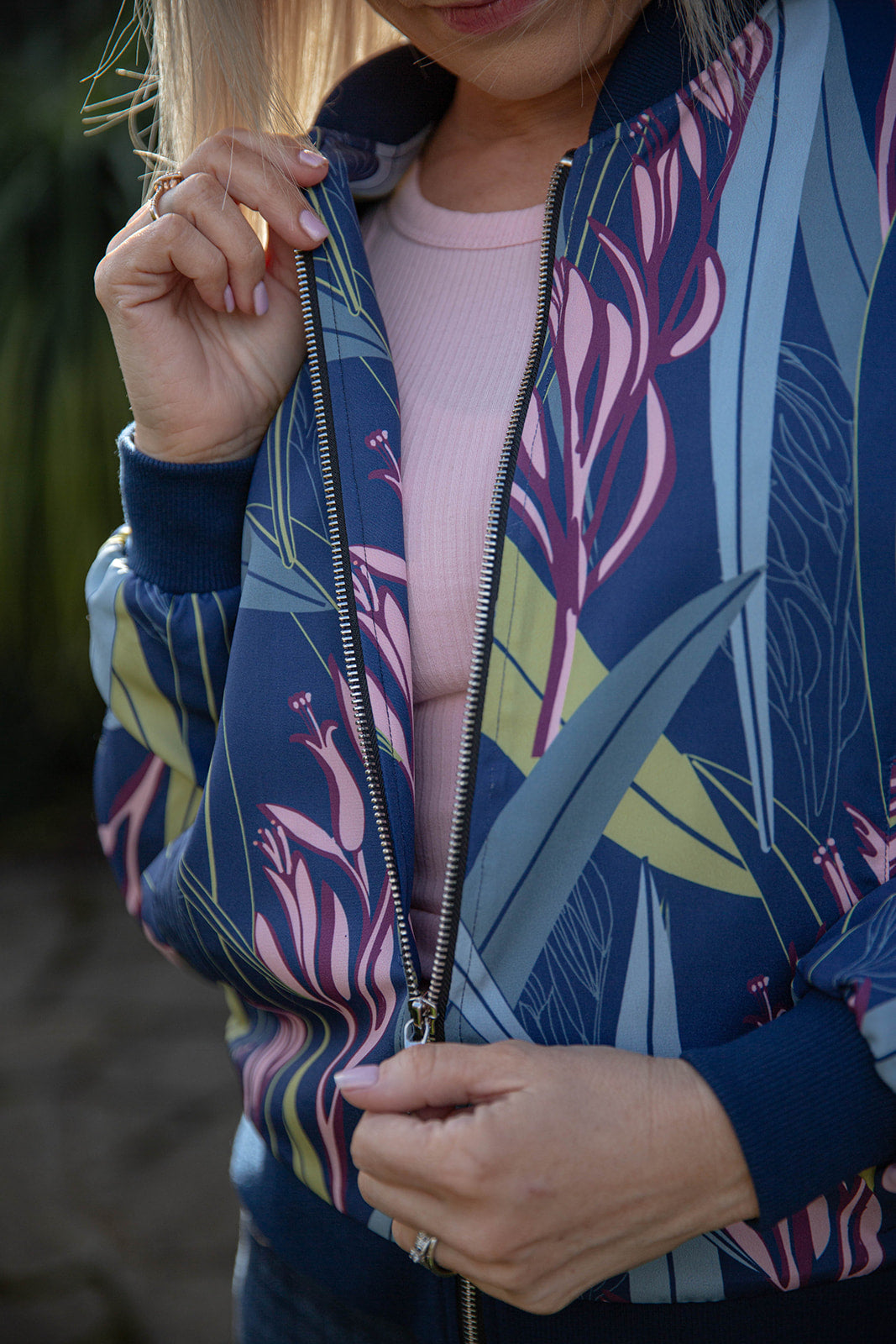 Kaleo Ladies Bomber Jacket in Blue Harakeke design, featuring New Zealand flax inspired print, lightweight zip-up women’s jacket perfect for casual and stylish outerwear