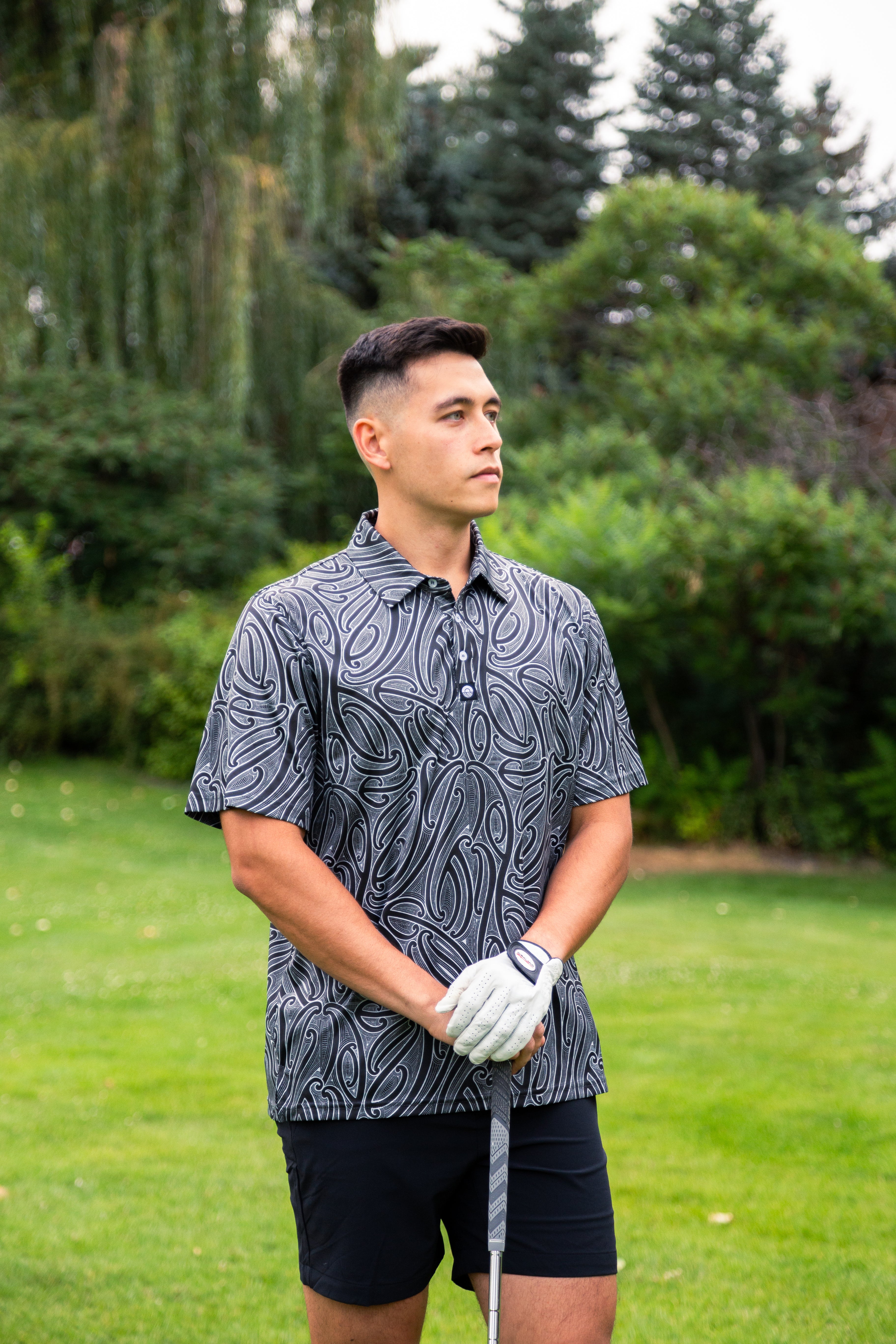 Men’s Kowhaiwhai golf polo shirt featuring bold black and white Māori-inspired design – premium performance golfwear from Kaleo New Zealand