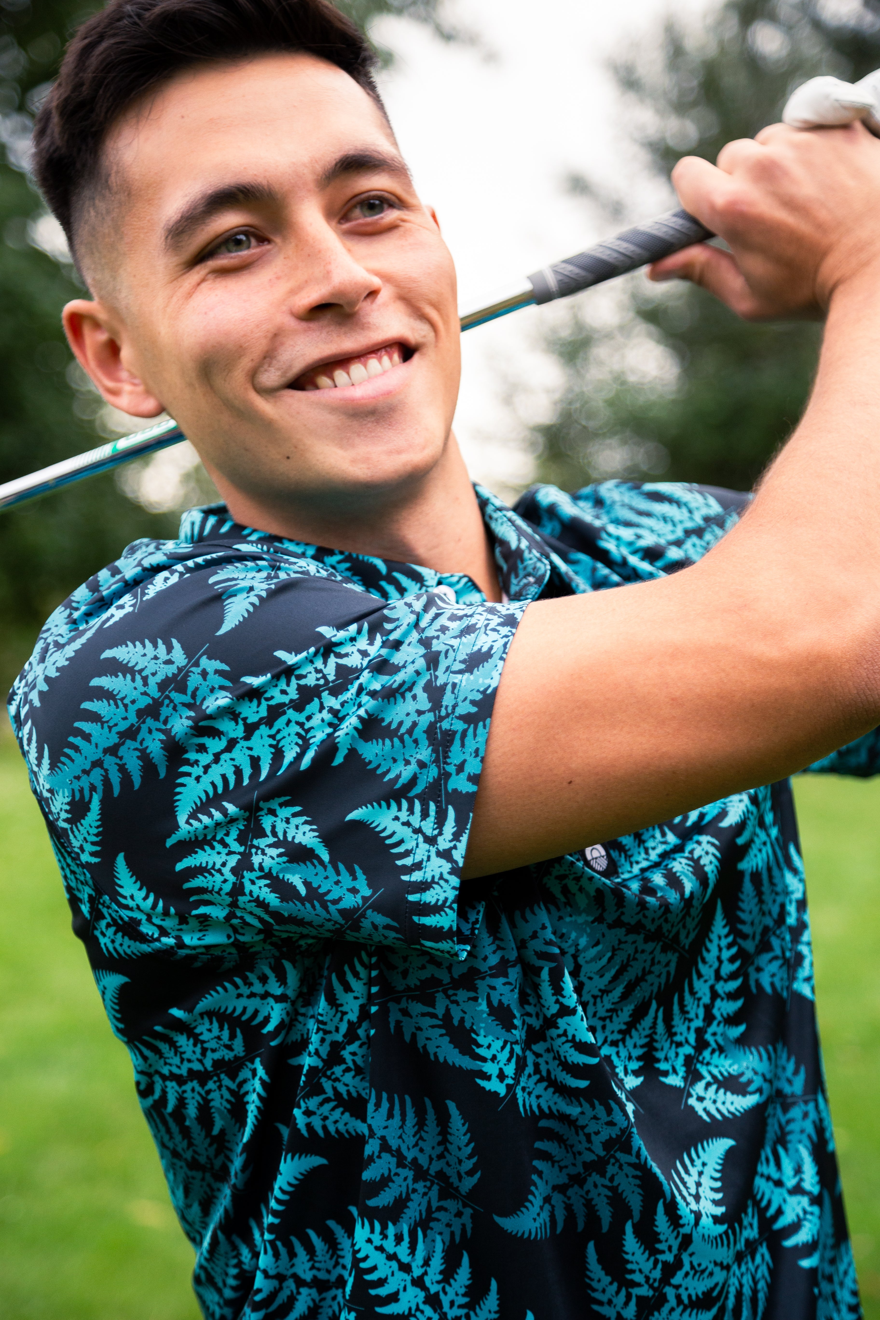 Men’s teal silver fern golf polo shirt with New Zealand native fern design – breathable, performance golfwear by Kaleo.