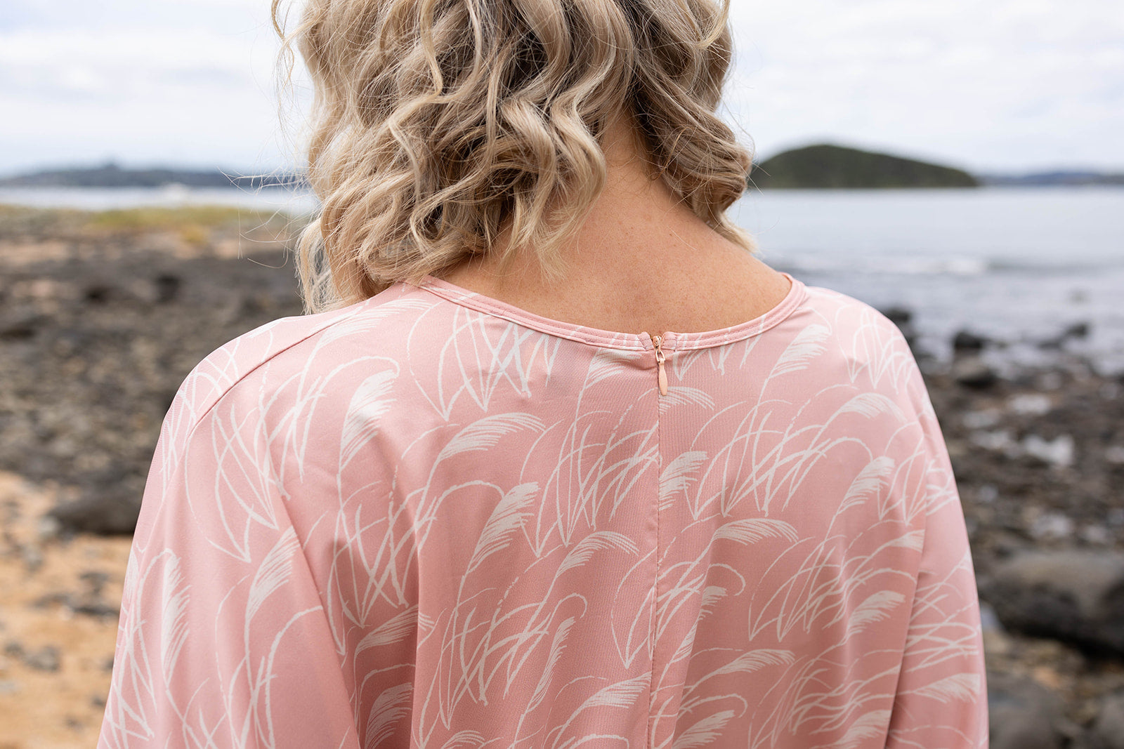 Women’s pink playsuit with white toe toe fern pattern – lightweight New Zealand inspired summer outfit with drawstring waist and short sleeves.