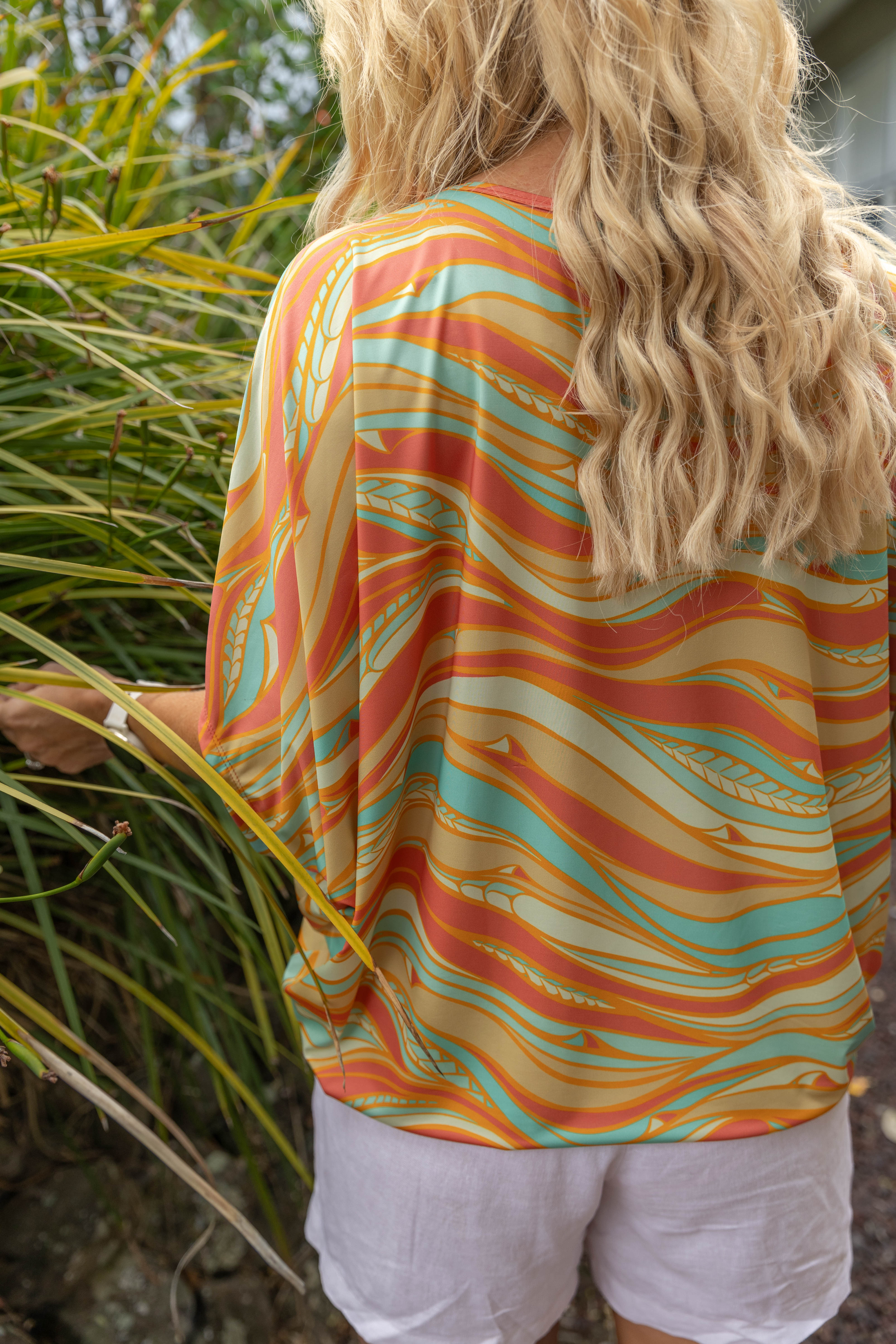 Women’s batwing top New Zealand – Te Rerenga coral print, NZ-designed wearable art by Kaleo; lightweight, travel-friendly women’s clothing with Kiwi style