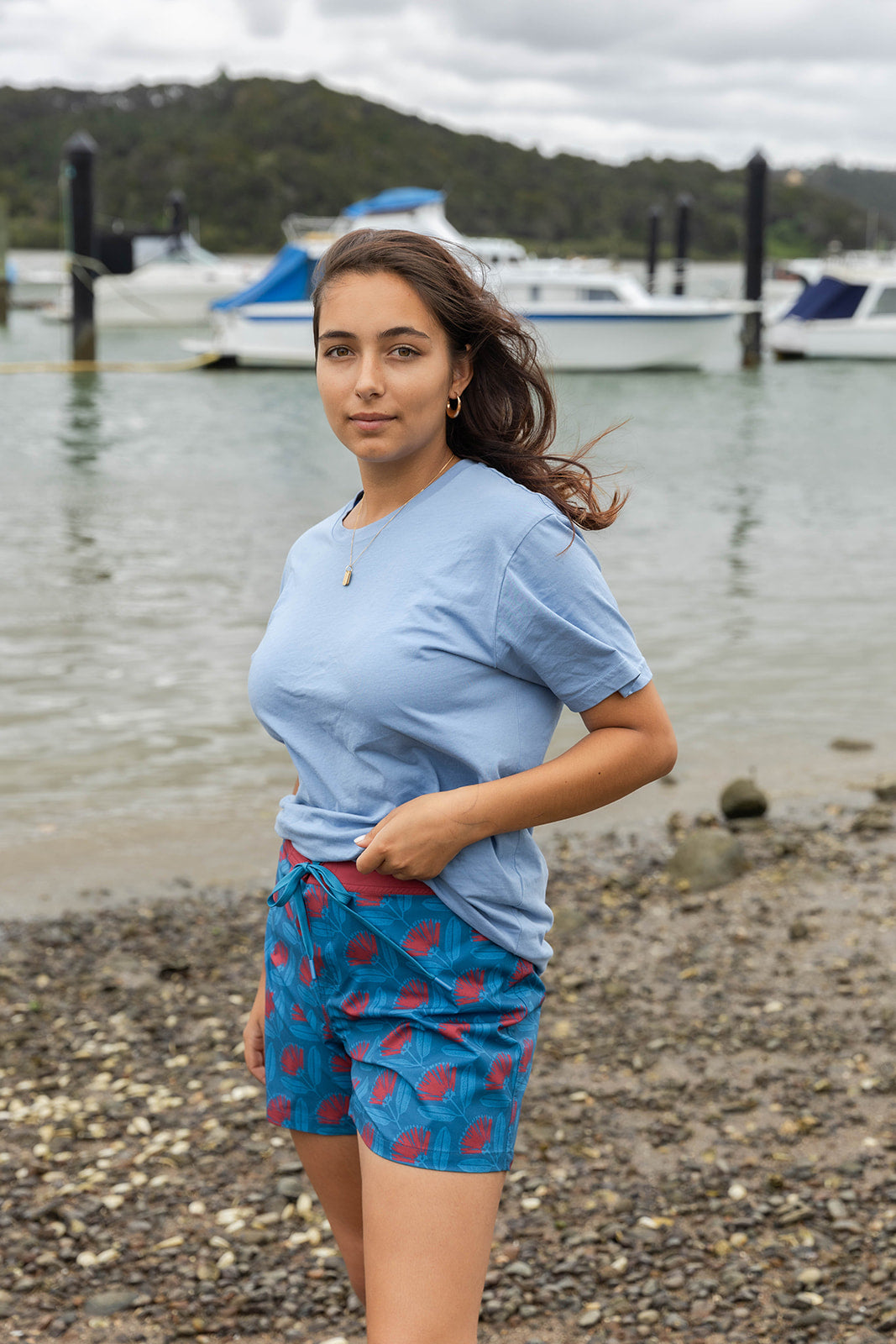 Women’s beachwear NZ – Pōhutukawa print board shorts, NZ-designed lightweight quick-dry boardies by Kaleo; travel-friendly holiday clothing with Kiwi style.