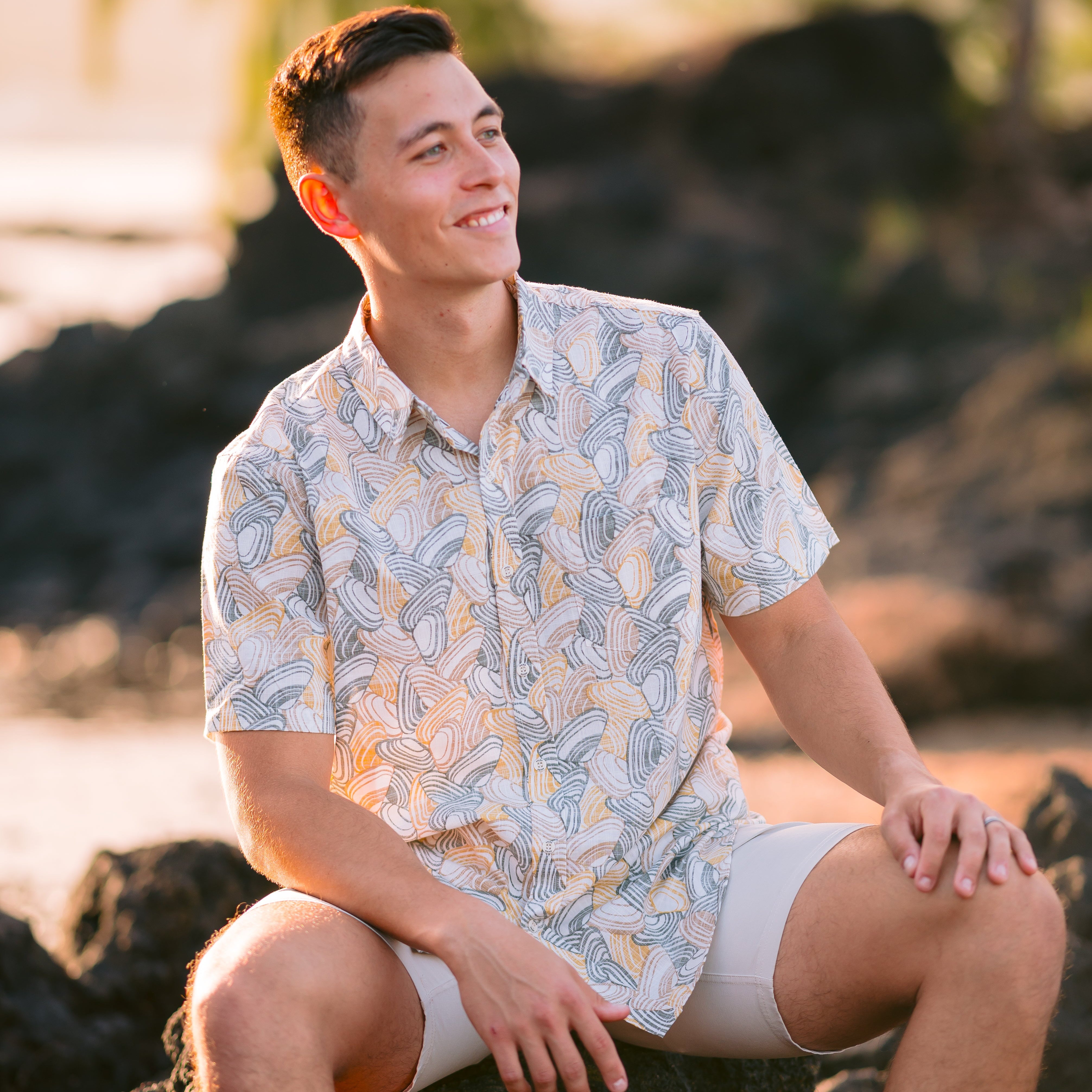 Men’s Pipi Shells Kiwi Classic short sleeve shirt in a coastal seashell print. Lightweight NZ summer shirt, casual beachwear, inspired by Kiwi lifestyle.