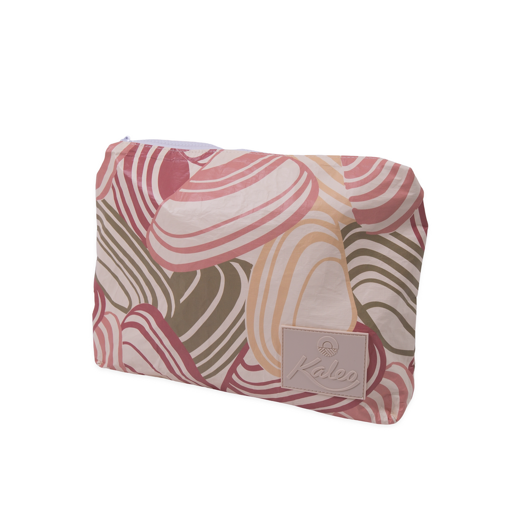 Pipi Shells splashproof pouch in coastal-inspired pink, beige, and olive shell print by Kaleo. Durable, water-resistant travel pouch ideal for beach trips, swimming, or everyday essentials. Lightweight and stylish New Zealand design, perfect for carrying swimwear, toiletries, or valuables while keeping them dry and protected.