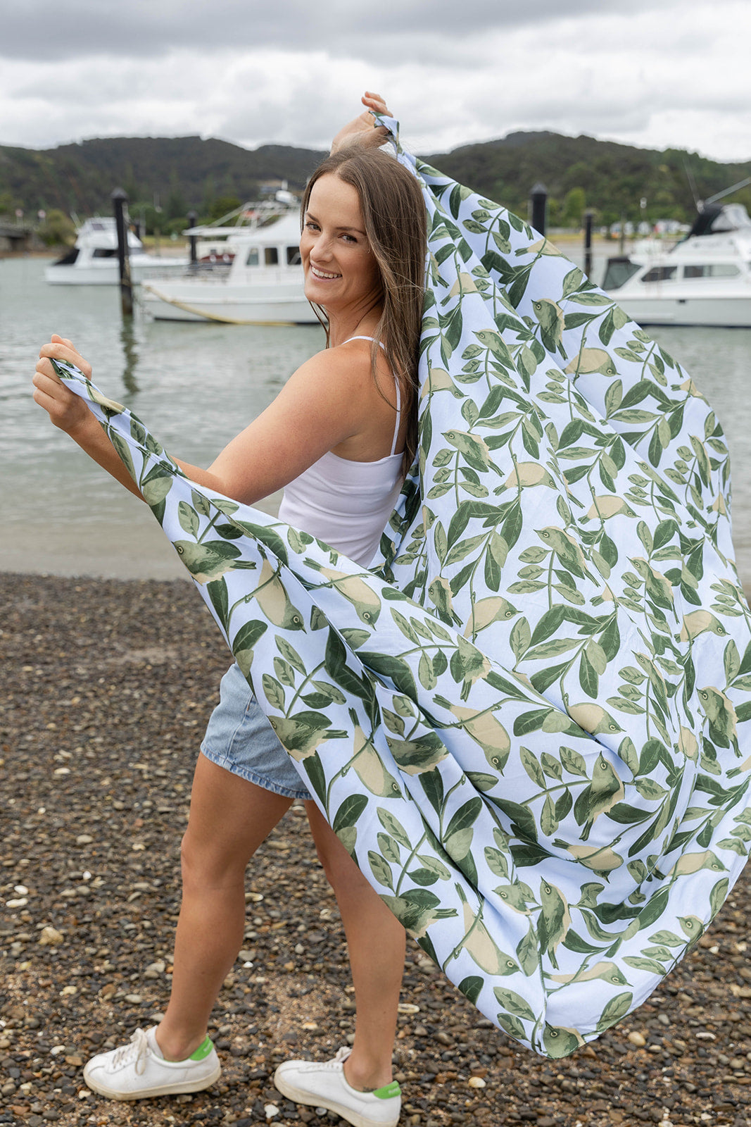 Women’s beachwear NZ – Blue Tauhou sarong featuring NZ bird and leaf print, original NZ-designed wearable art by Kaleo. Lightweight holiday clothing