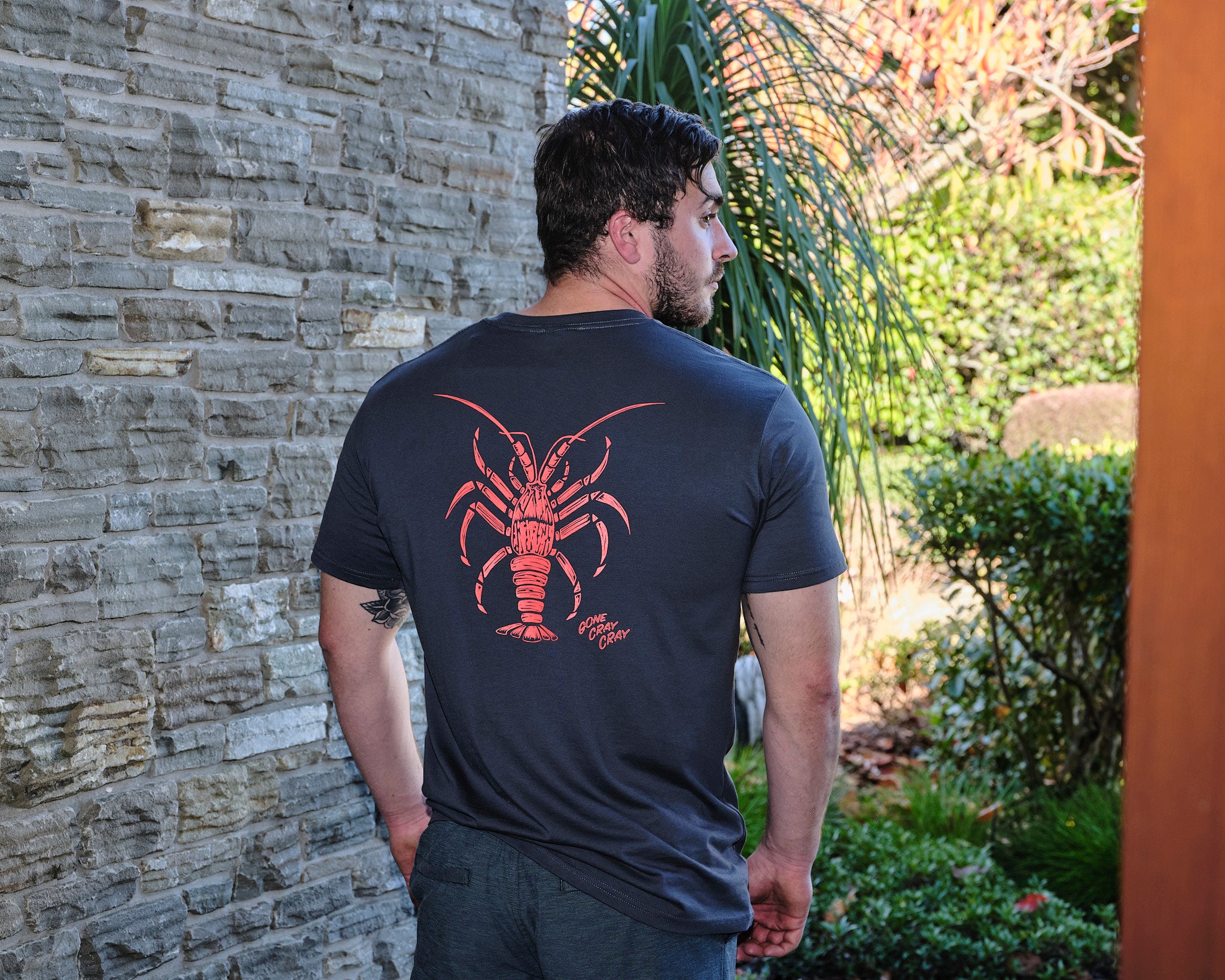 Men’s charcoal t-shirt with bold orange crayfish graphic and ‘Gone Cray Cray’ text – fun New Zealand seafood inspired tee