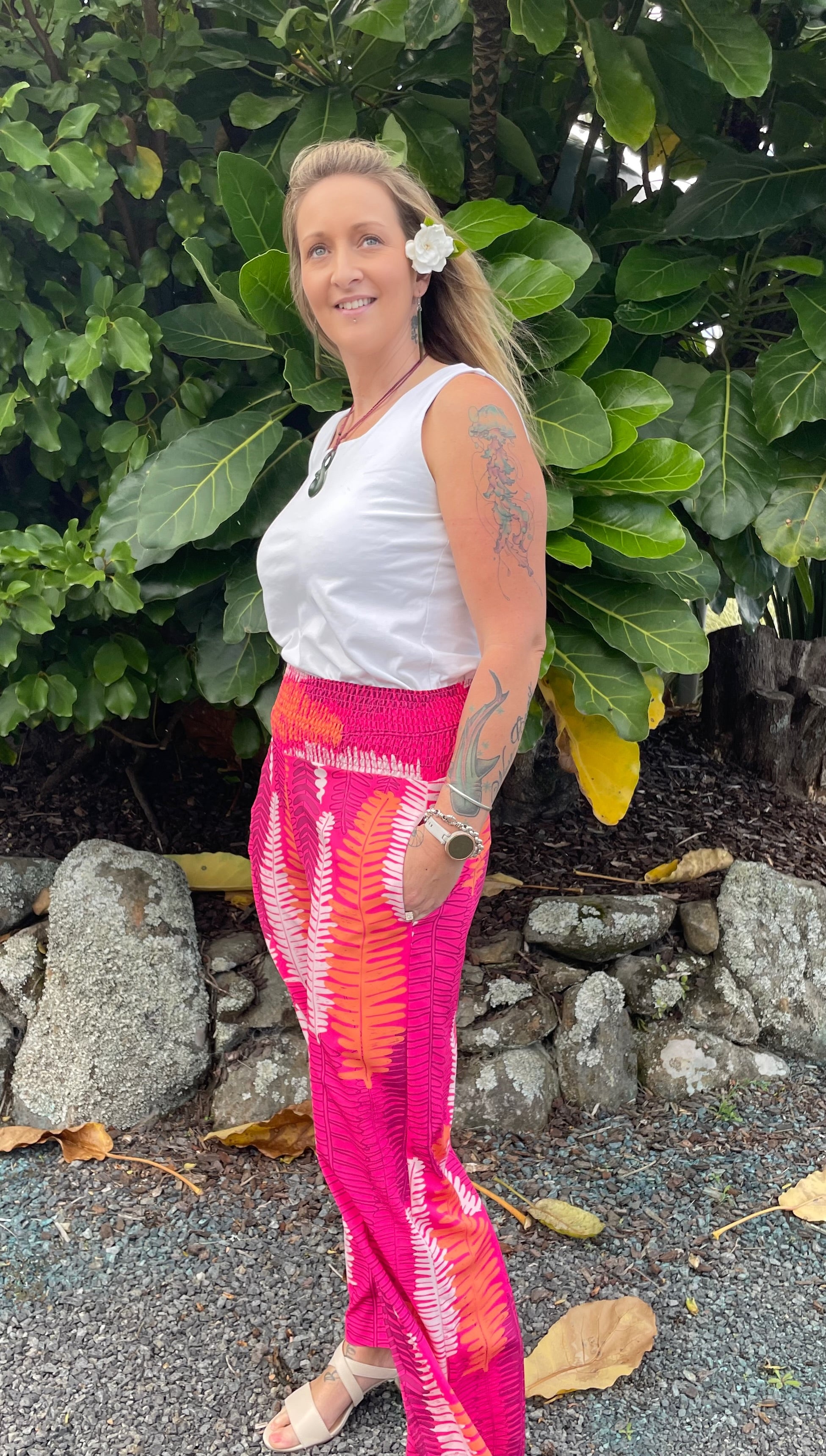 Women’s wide-leg pants in hot pink with Piupiu fern print – bold New Zealand inspired smocked waist trousers.