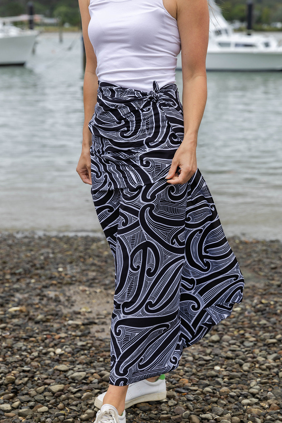 Women’s beachwear NZ – Kōwhaiwhai sarong with Māori-inspired design, NZ-designed wearable art by Kaleo. Lightweight holiday clothing and unique Kiwi gift