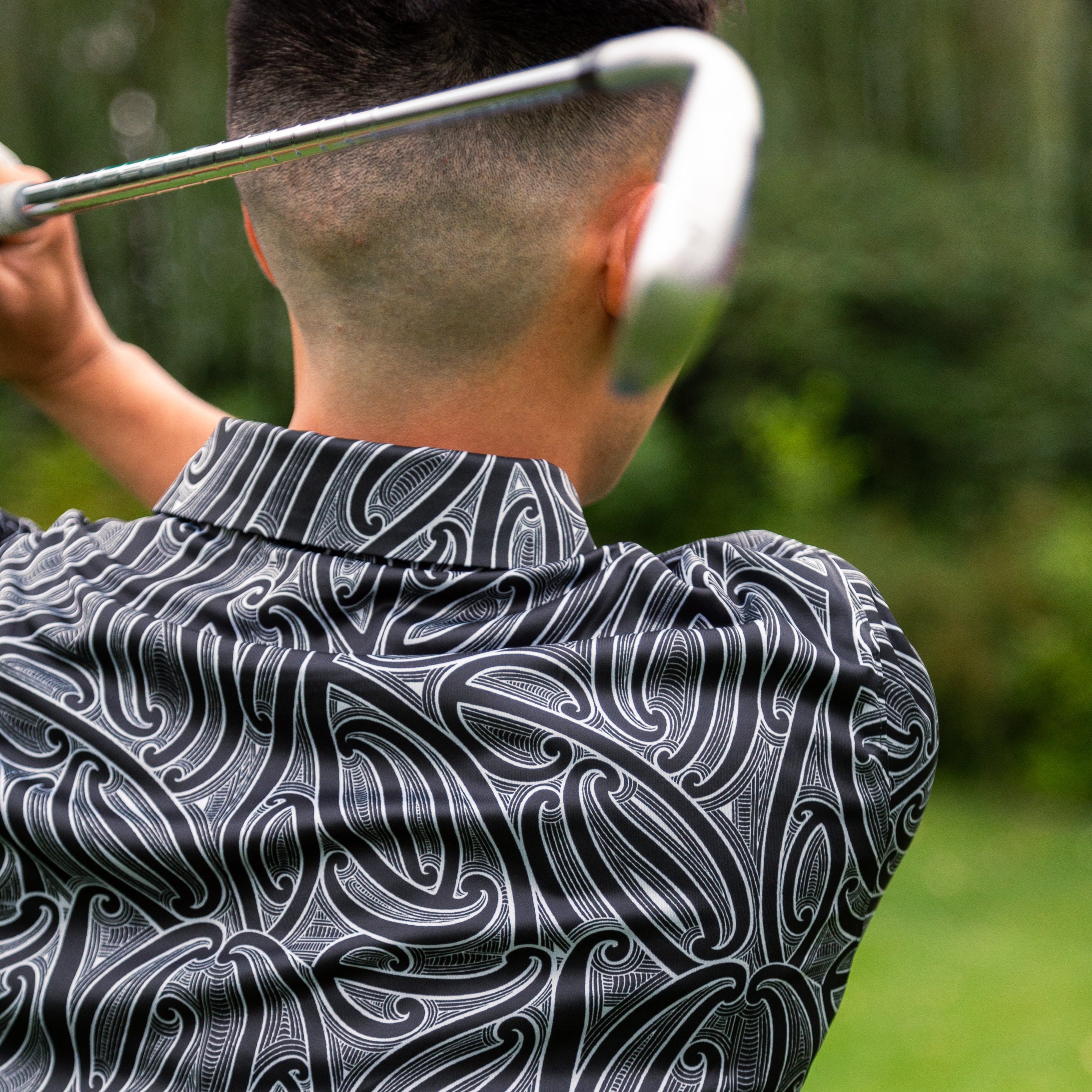 Men’s Kowhaiwhai golf polo shirt featuring bold black and white Māori-inspired design – premium performance golfwear from Kaleo New Zealand
