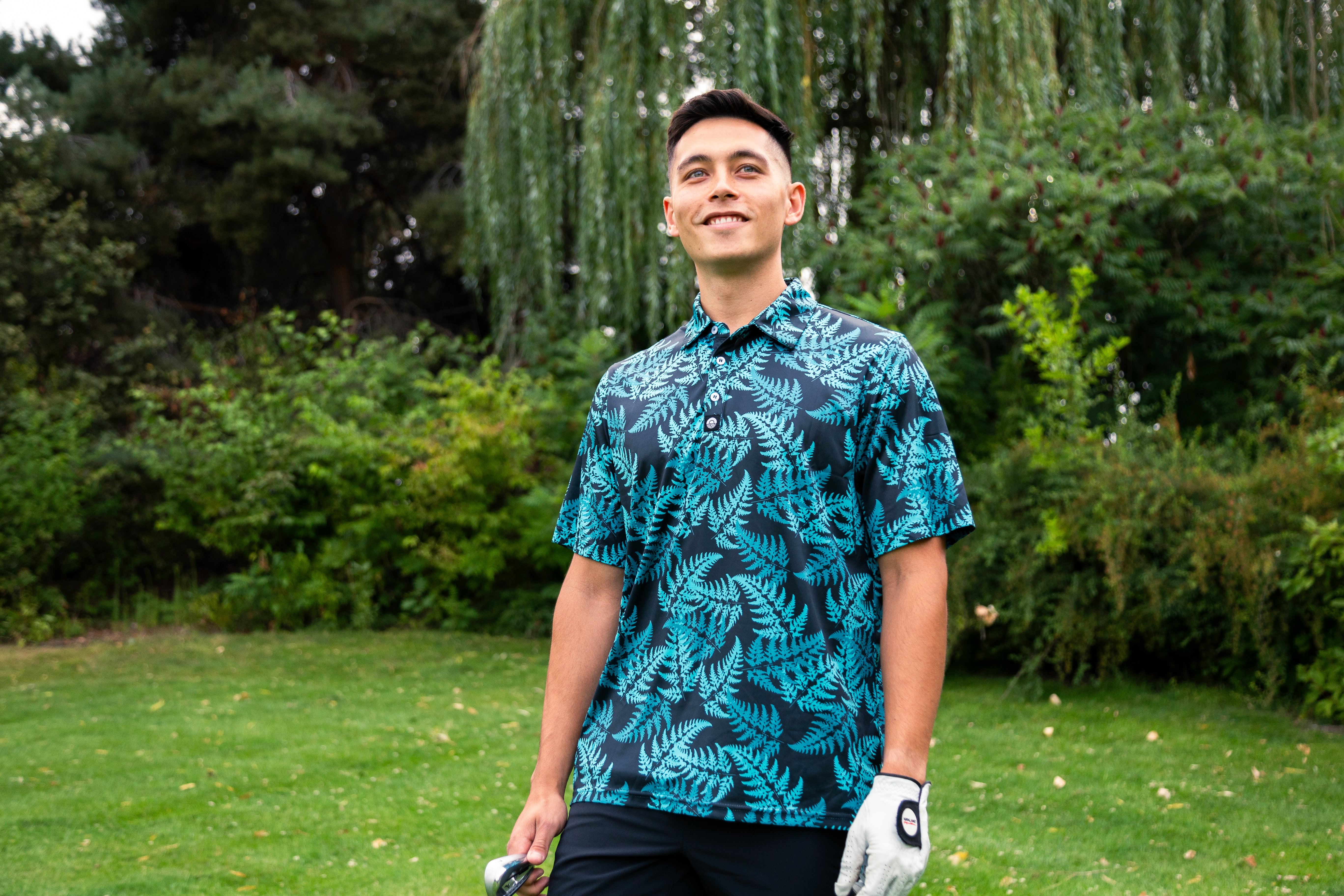 Men’s teal silver fern golf polo shirt with New Zealand native fern design – breathable, performance golfwear by Kaleo