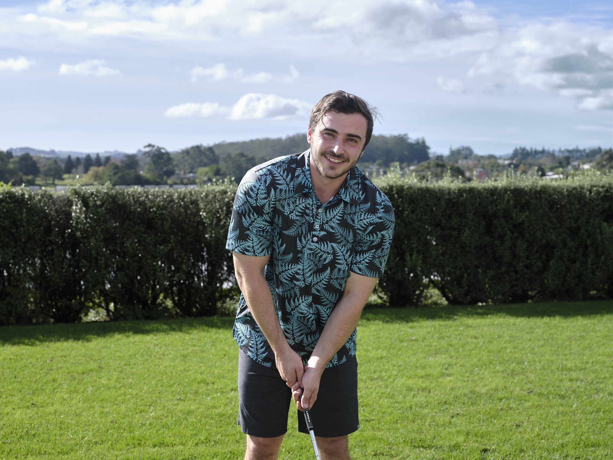 Men’s teal silver fern golf polo shirt with New Zealand native fern design – breathable, performance golfwear by Kaleo.