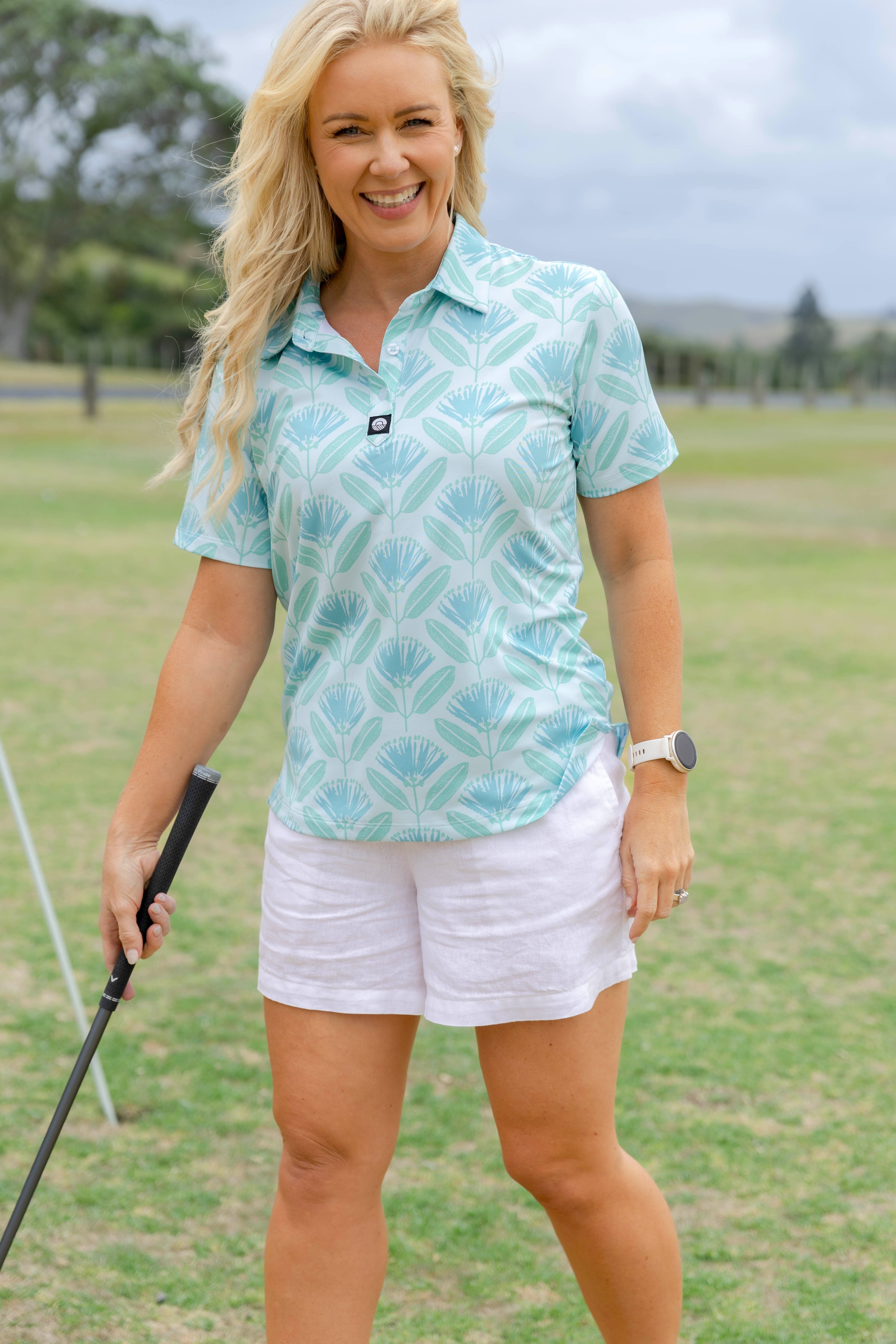 Women’s aqua blue Pohutukawa golf polo shirt featuring native New Zealand floral print – stylish, lightweight and breathable golfwear by Kaleo.