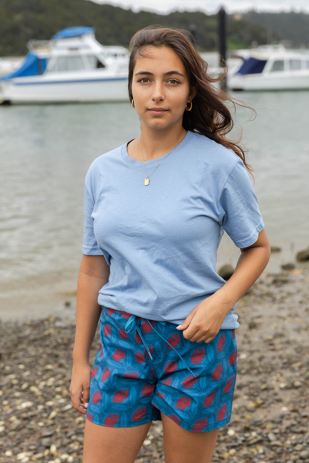Women’s beachwear NZ – Pōhutukawa print board shorts, NZ-designed lightweight quick-dry boardies by Kaleo; travel-friendly holiday clothing with Kiwi style.