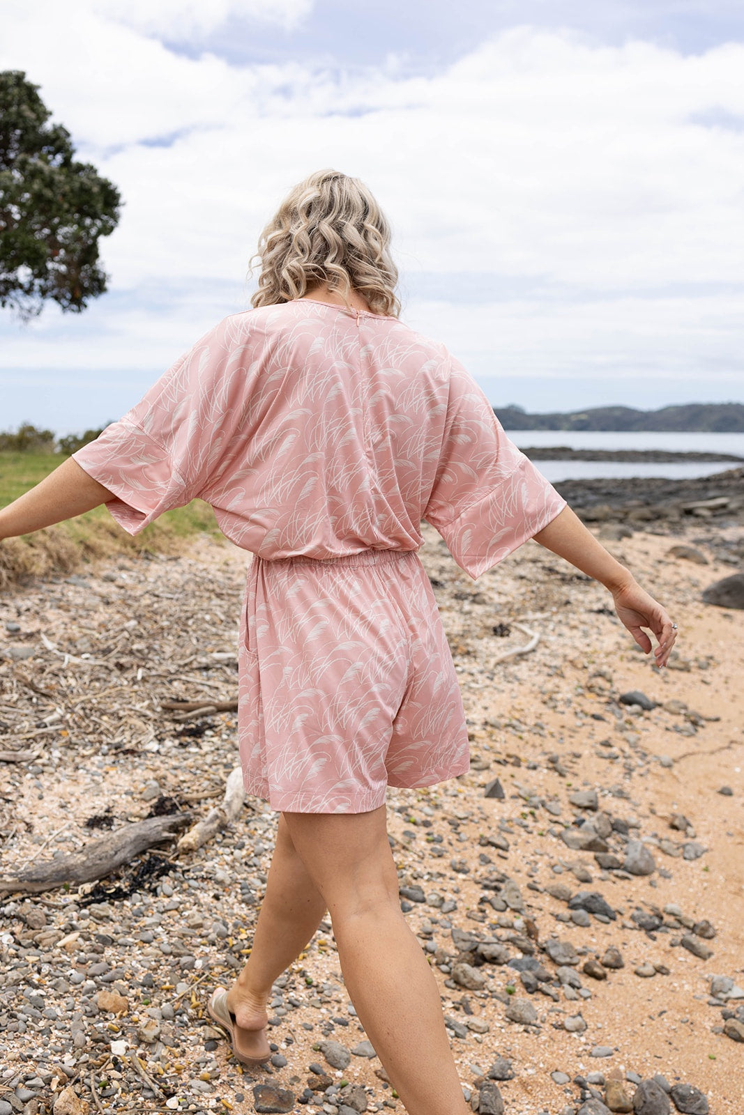 Women’s pink playsuit with white toe toe fern pattern – lightweight New Zealand inspired summer outfit with drawstring waist and short sleeves